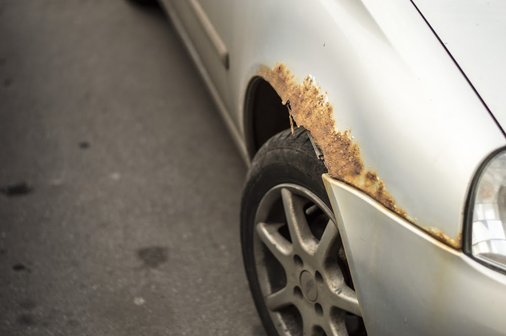 rust on car above front wheel