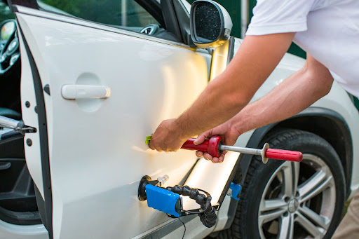 person performing paintless dent repair